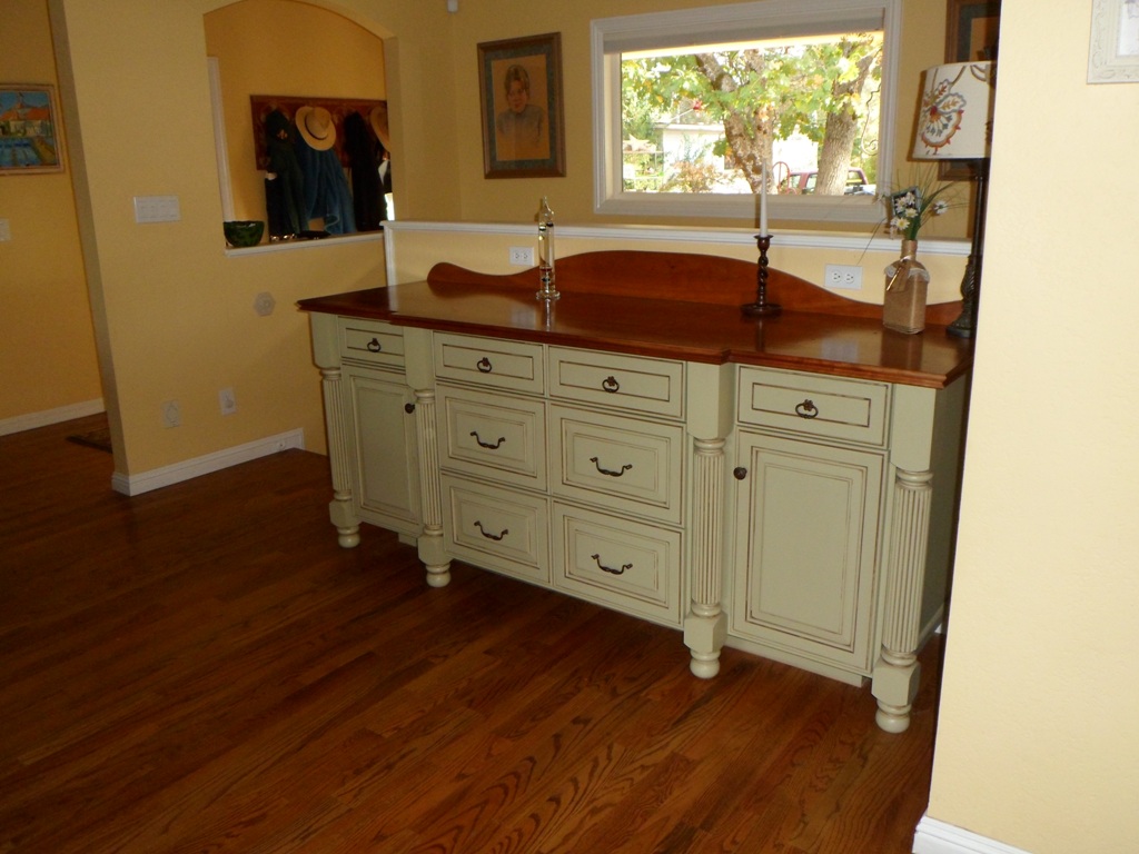 buffet cabinet with turned columns and reeding topped with a solid wood cherry top