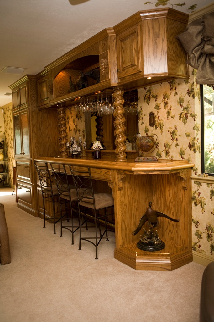 Red oak bar with glass racks and spiral carved columns