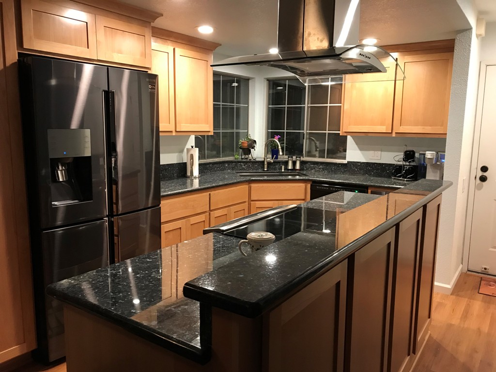 Shaker style clear Alder kitchen features full size wall cabinets.