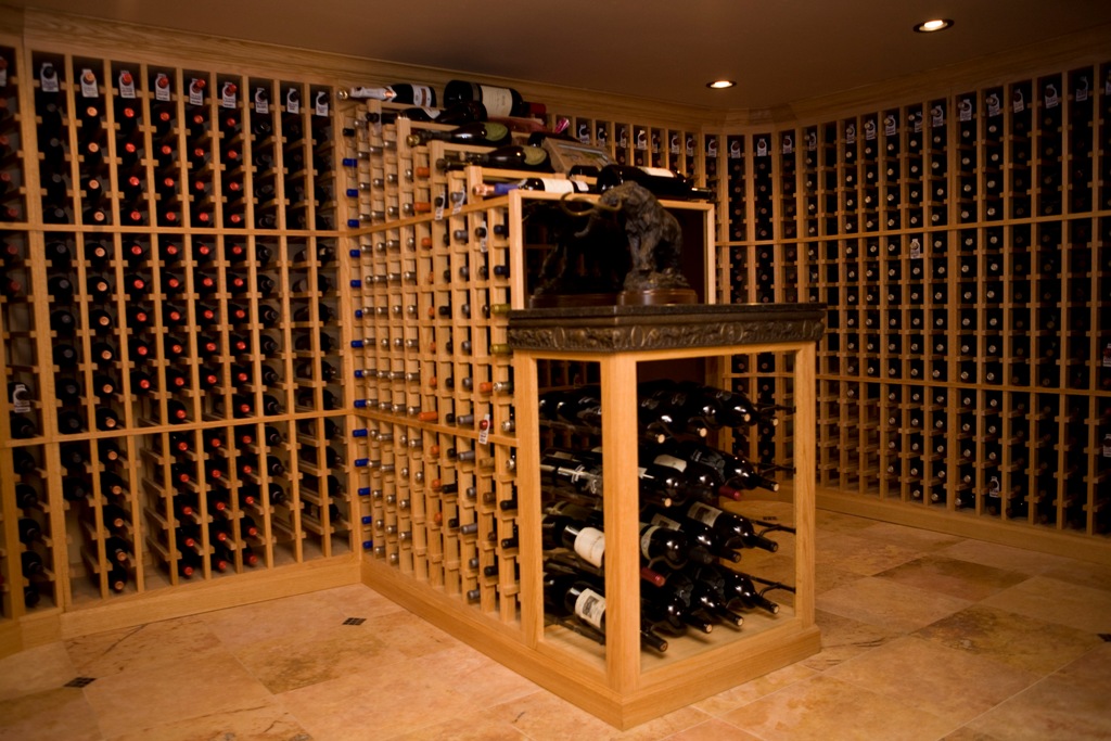 Cascade wine bottle display cabinet crafted in red oak with a hand rubbed finish