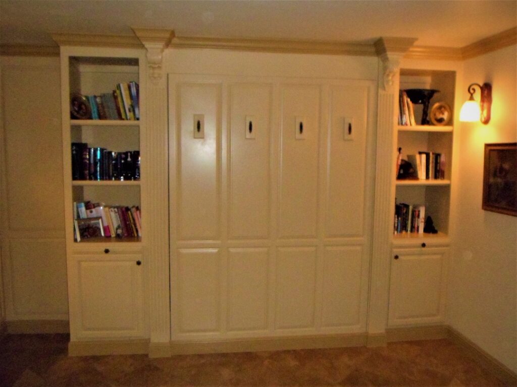 Murphy bed with built in bookcases and raised panel wainscoting